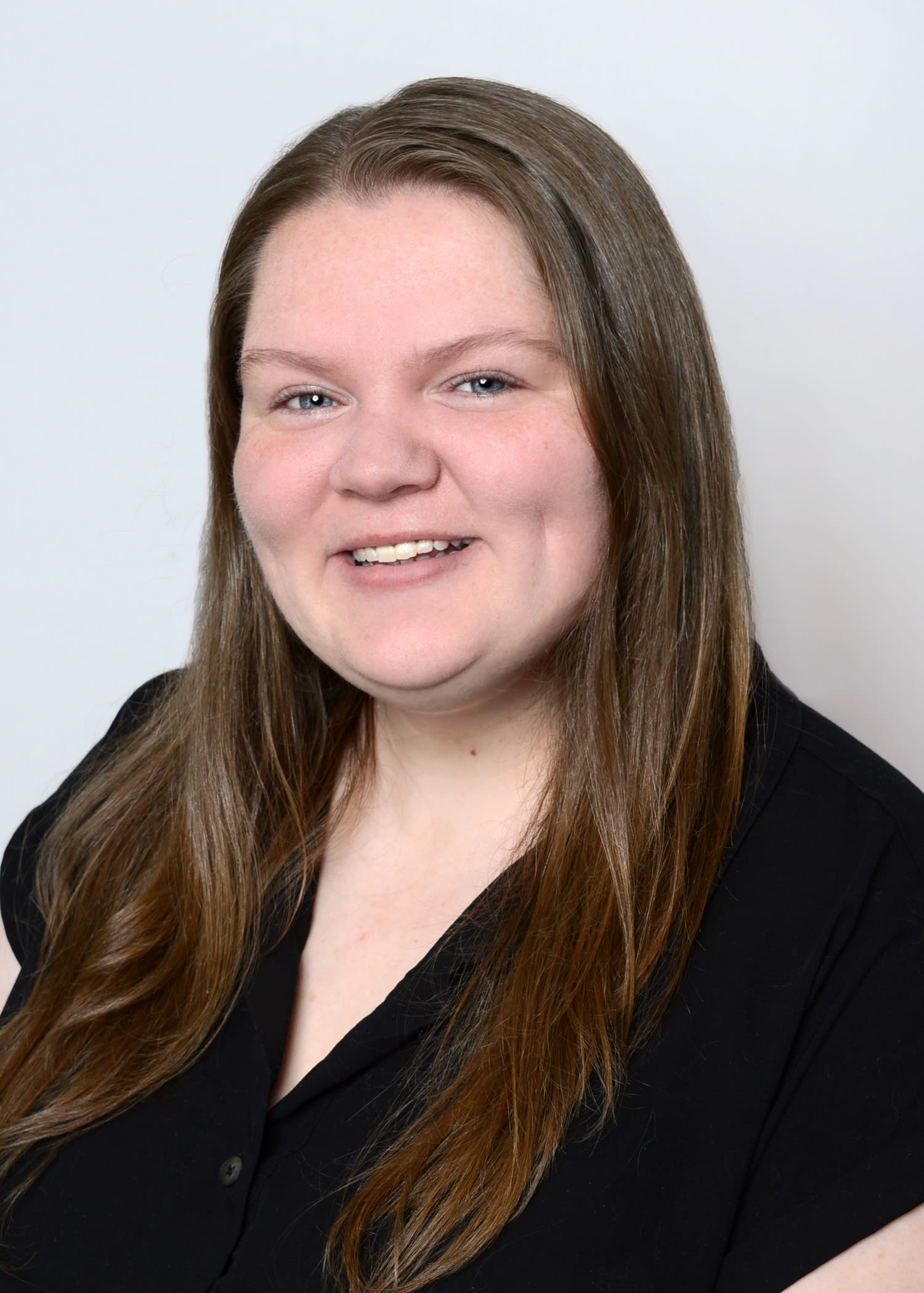 Smiling woman with long brown hair headshot